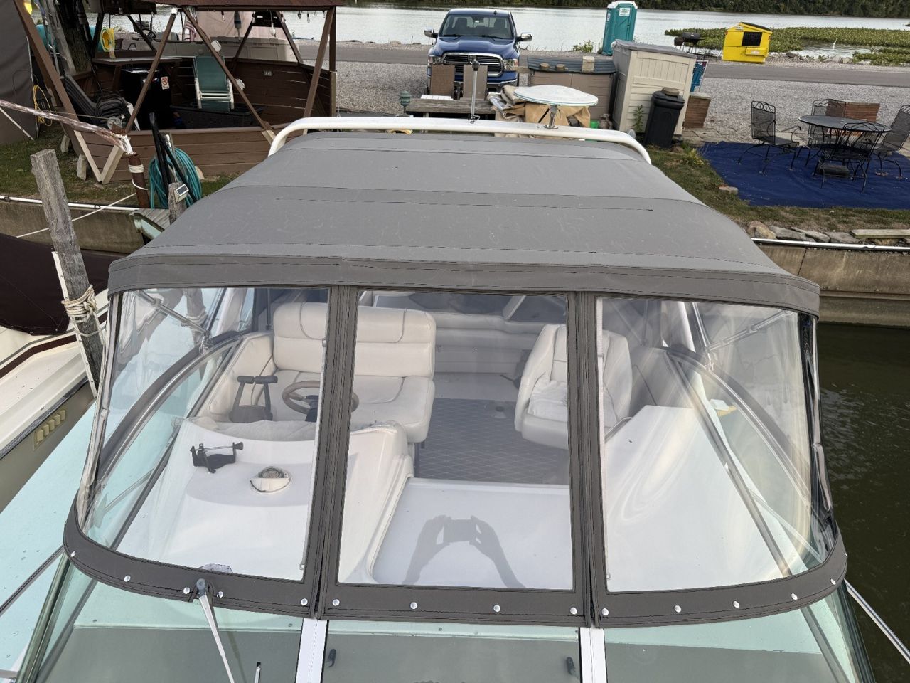 Blue canvas enclosure fitted around a boat cockpit